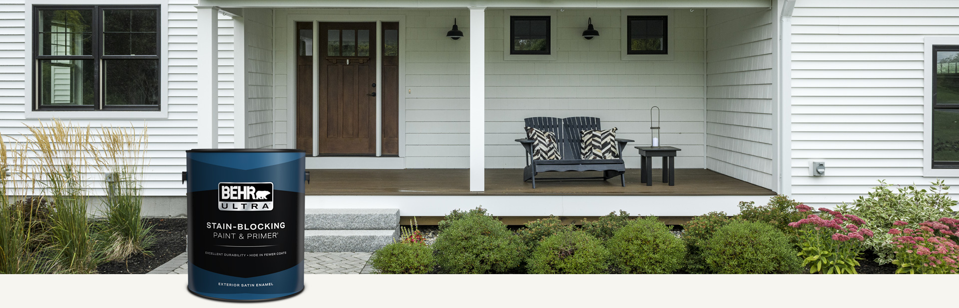 White house exterior with a can of Behr Ultra Exterior Satin Enamel in foreground